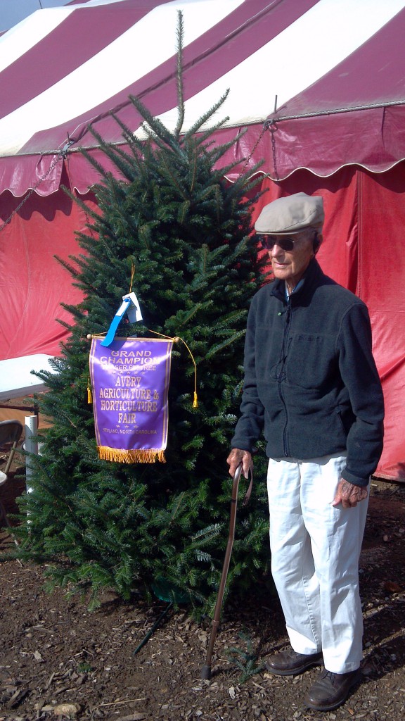 Sam Cartner poses with his grand champion tree at the Avery County Agriculture Fair.